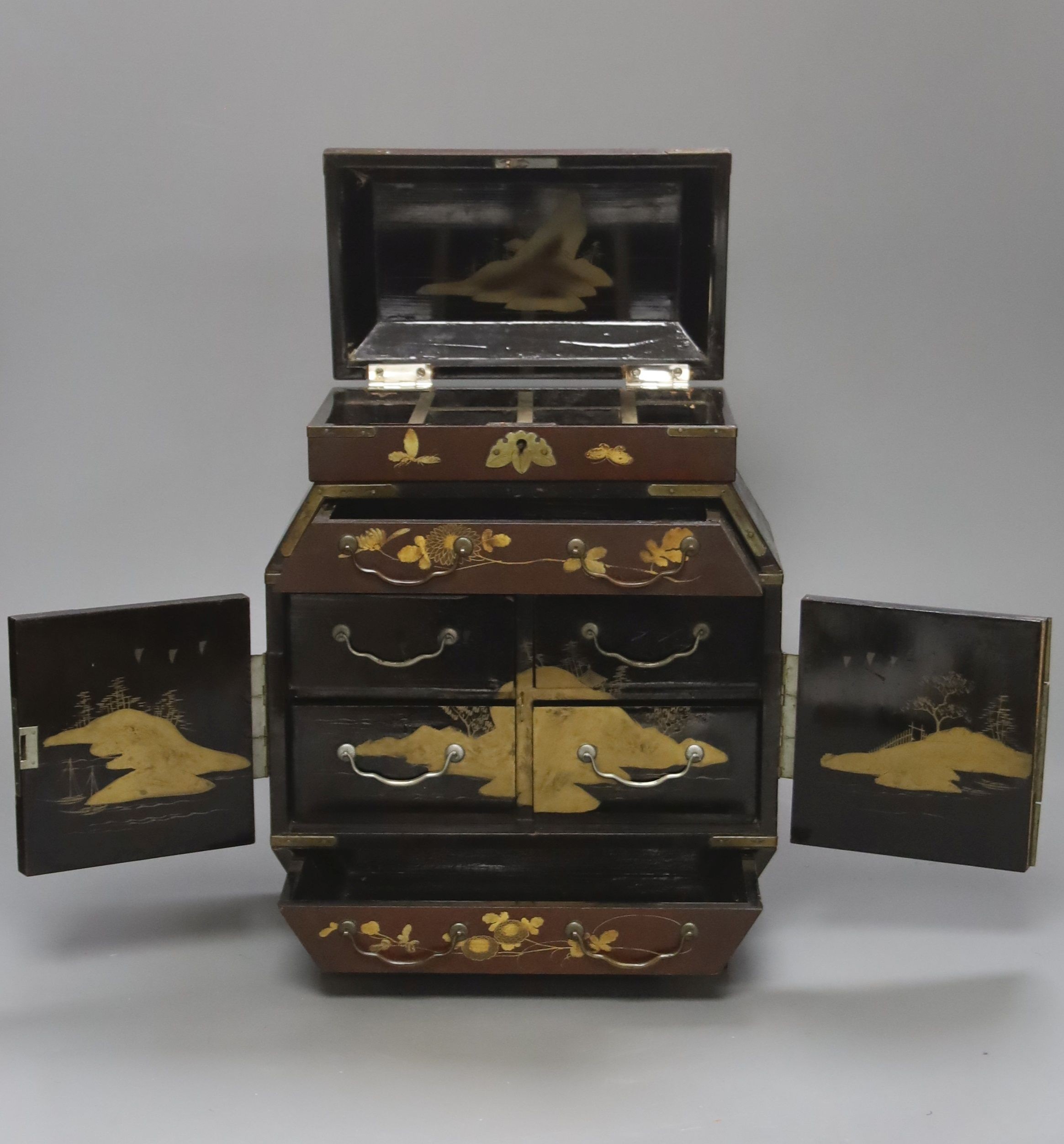 A Japanese lacquered brass bound table top cabinet, height 28cm